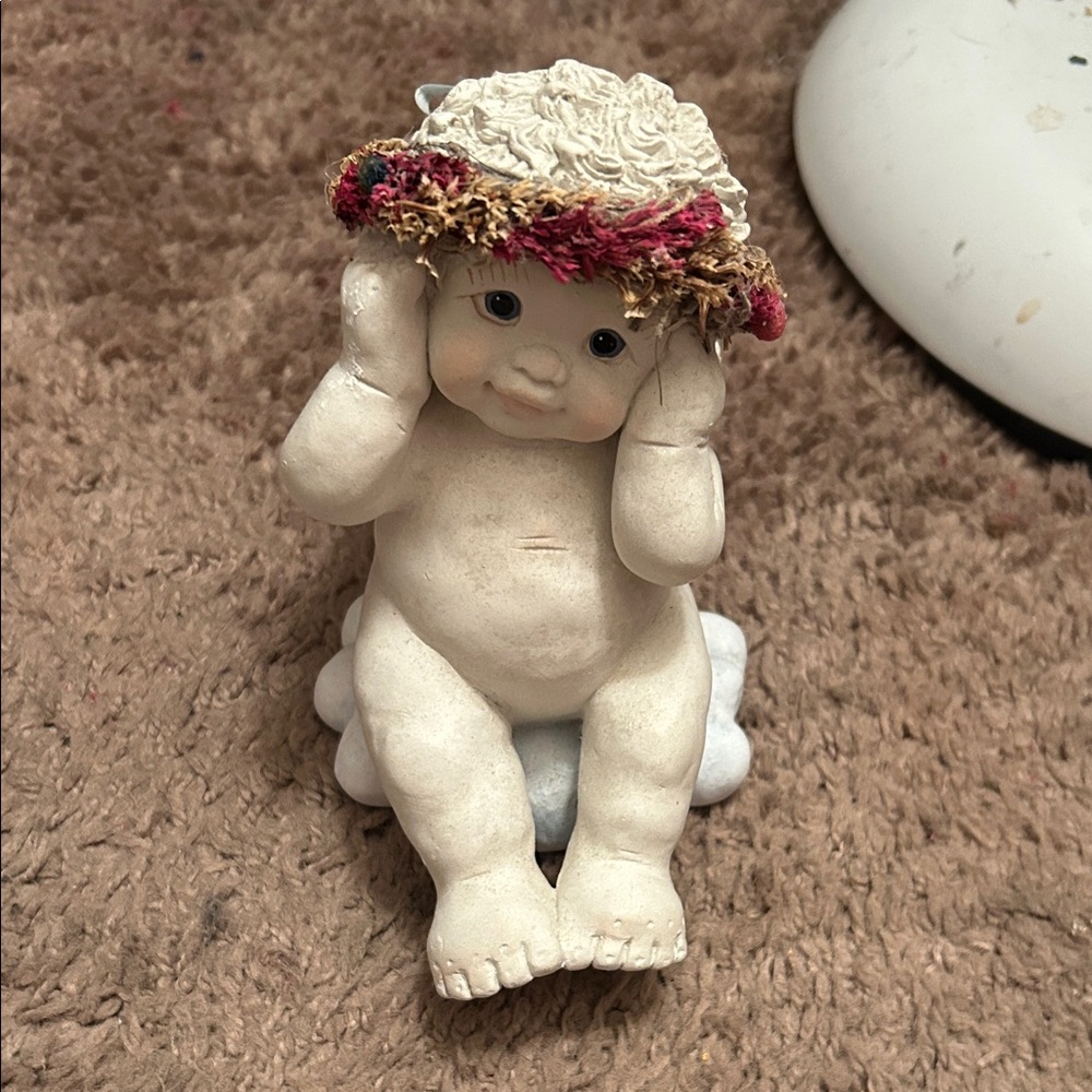 Hear no evil 
Charming Cream Figurine with Floral Hat